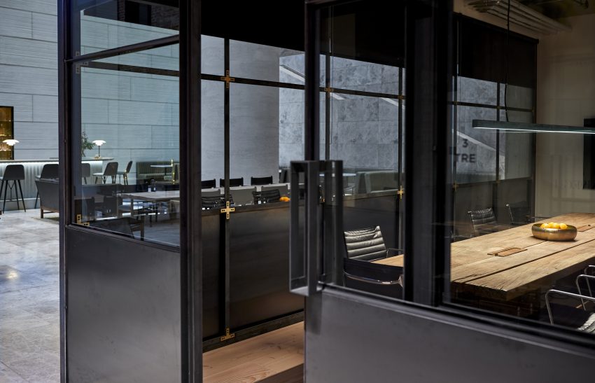 A posh black office corporate space, showcasing a posh bar in the background of the room