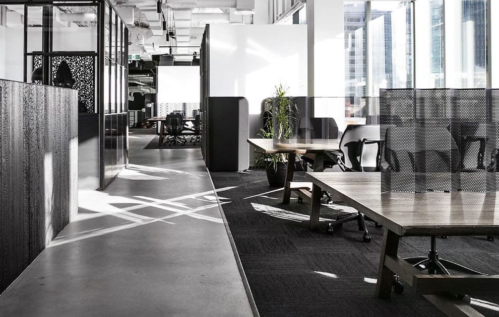 A nice coworking or corporate office space, up high in a building, with dark aesthetic colouring