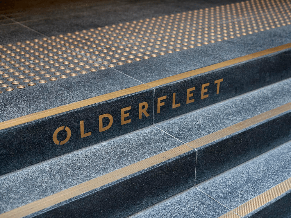 Small stone stairs with golden text in the middle of the top stair that reads the word 