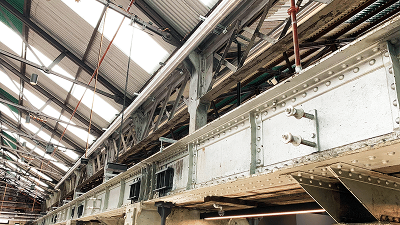 A close up view of scaffolding and metal beams holding a warehouse together