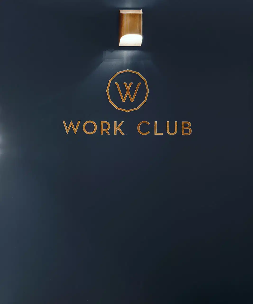 Work Club sign illuminated by down light