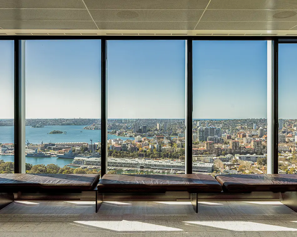 Floor-to-ceiling windows and a window seat overlooking Sydney Harbour and the city